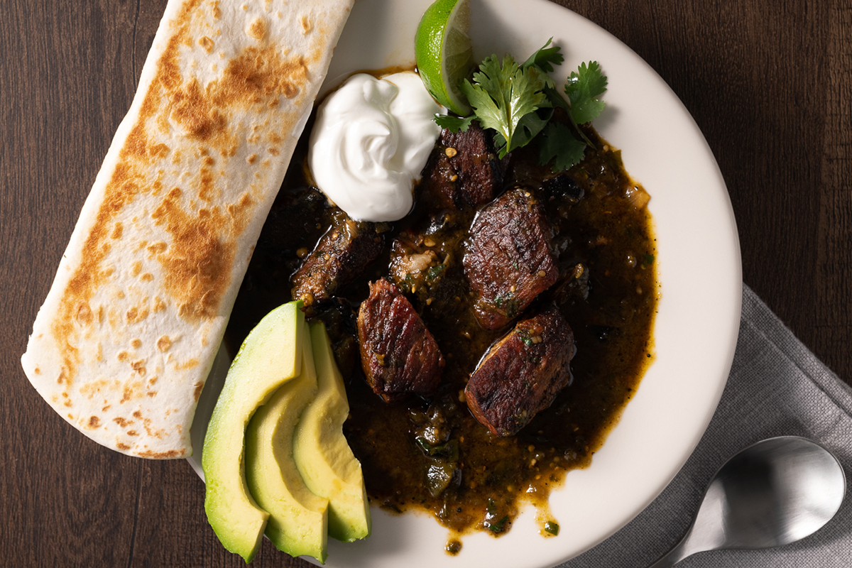 Pork shoulder butt served alongside avocado slices, sour cream and tortillas | Prairie Fresh®