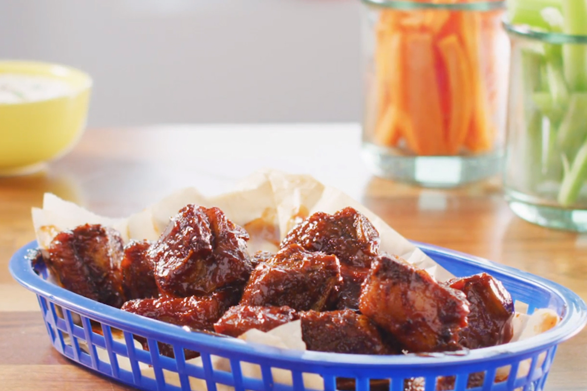Air-fried pork riblets brushed with smoky barbecue sauce in a blue basket | Prairie Fresh®
