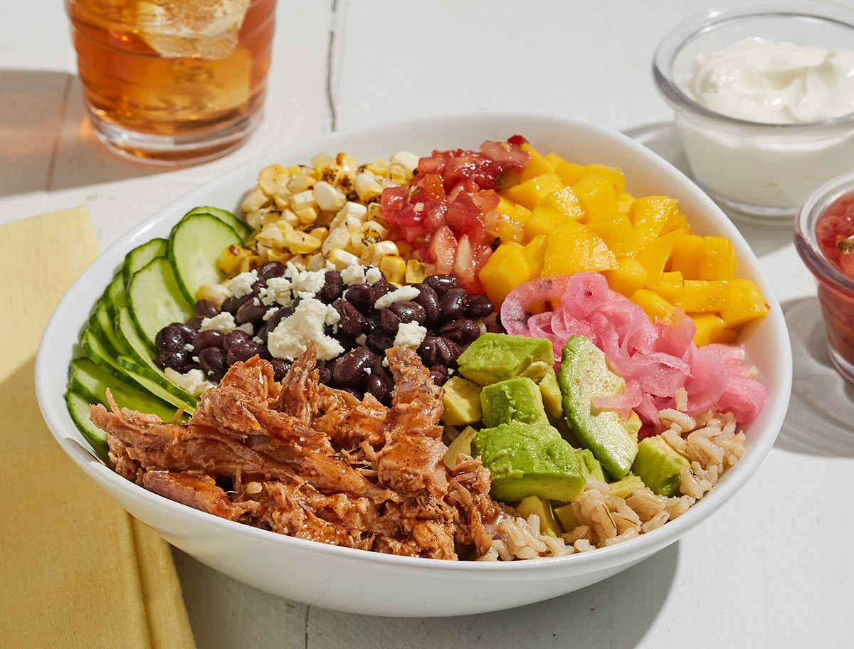 Burrito bowl with spicy pulled pork, colorful vegetables, cheese and brown rice | Prairie Fresh®