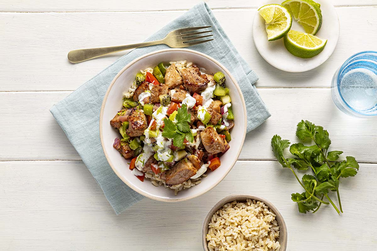 Teriyaki-glazed pork tenderloin cubes served in bowls with brown rice and fresh toppings | Prairie Fresh®